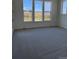 Carpeted bedroom offering three big windows, a neutral color palette and plenty of natural light at 901 Coal Bank Trl, Castle Rock, CO 80104