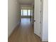 Bright hallway with hardwood floors leading to a room with large windows, filled with natural light at 901 Coal Bank Trl, Castle Rock, CO 80104