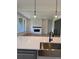 Open kitchen with a stylish sink, modern pendant lights, and fireplace with a white brick surround at 901 Coal Bank Trl, Castle Rock, CO 80104