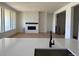 Living room showcasing hardwood floors, a sleek fireplace with white brick surround, and abundant natural light at 901 Coal Bank Trl, Castle Rock, CO 80104