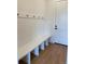 Functional mudroom with a built-in bench, coat hooks, and hardwood floors, offering convenience and organization at 901 Coal Bank Trl, Castle Rock, CO 80104