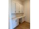 Bright office space featuring white cabinets, a built-in desk, and sleek hardwood floors at 901 Coal Bank Trl, Castle Rock, CO 80104