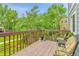 Wooden back deck with chairs overlooking a fenced yard and trees at 11404 W Sharkstooth Peak, Littleton, CO 80127