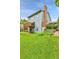 Backyard with well-kept lawn, brick chimney, and walkout deck at 11404 W Sharkstooth Peak, Littleton, CO 80127