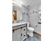 Bathroom with light grey walls, modern sink and faucet, toilet and dark floor at 11404 W Sharkstooth Peak, Littleton, CO 80127
