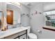 Bathroom with light grey walls, modern sink and faucet, toilet and window at 11404 W Sharkstooth Peak, Littleton, CO 80127