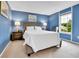 Comfortable bedroom with a large bed, side tables, and a bright window view at 11404 W Sharkstooth Peak, Littleton, CO 80127