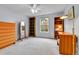 Spacious bedroom with grey carpet, light blue walls, and built-in bookshelves at 11404 W Sharkstooth Peak, Littleton, CO 80127