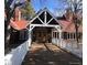 A welcoming wood clubhouse featuring large windows, a red roof, and a quaint entry bridge at 11404 W Sharkstooth Peak, Littleton, CO 80127