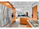 Gourmet kitchen with stainless steel appliances opening to the living room at 11404 W Sharkstooth Peak, Littleton, CO 80127