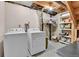 Basement laundry room with washer, dryer and utility shelving at 11404 W Sharkstooth Peak, Littleton, CO 80127