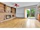 Spacious living room features a brick fireplace, wood floors, and sliding glass doors to a patio at 11404 W Sharkstooth Peak, Littleton, CO 80127