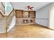 Cozy living area with a brick fireplace, built-in shelves, and hardwood floors at 11404 W Sharkstooth Peak, Littleton, CO 80127