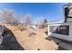 An expansive backyard with a sunroom and space for outdoor activities at 8271 Bluebell Way, Denver, CO 80221