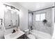 Modern bathroom features marble tile, bathtub, and contemporary vanity with undermount sink at 8271 Bluebell Way, Denver, CO 80221
