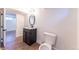 Bathroom features vinyl plank flooring, new vanity and mirror, and toilet at 8271 Bluebell Way, Denver, CO 80221