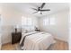 Charming bedroom features neutral decor, wood floors, and a comfortable bed at 8271 Bluebell Way, Denver, CO 80221