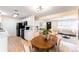 Open-concept dining area connecting the kitchen and living room at 8271 Bluebell Way, Denver, CO 80221