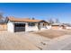 Well-maintained single-story home with gray garage door and spacious driveway at 8271 Bluebell Way, Denver, CO 80221