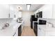 Modern kitchen with sleek white cabinets, updated appliances, and stylish backsplash at 8271 Bluebell Way, Denver, CO 80221