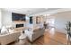 Bright living room with modern fireplace, hardwood floors and neutral tones at 8271 Bluebell Way, Denver, CO 80221