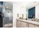 Sleek bathroom with double vanity, modern fixtures, and tiled walk-in shower at 1323 Elati St # 3, Denver, CO 80204