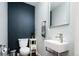 Stylish powder room with modern fixtures, bold accent wall, and sleek design at 1323 Elati St # 3, Denver, CO 80204