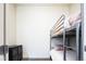 Minimalist bedroom with a metal bunk bed, gray carpeting, and a black storage unit at 1323 Elati St # 3, Denver, CO 80204
