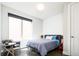 Cozy bedroom with large window providing natural light and modern furnishings at 1323 Elati St # 3, Denver, CO 80204