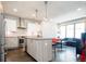 Open kitchen with island, stainless steel appliances, and seamless transition to the living area at 1323 Elati St # 3, Denver, CO 80204