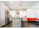 Modern kitchen featuring stainless steel appliances, light wood cabinetry and an island with seating at 1323 Elati St # 3, Denver, CO 80204