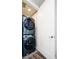 Efficient laundry room features a stacked washer and dryer behind a modern door at 1323 Elati St # 3, Denver, CO 80204
