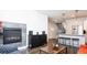View of the living room featuring a fireplace, large window, and modern furnishings at 1323 Elati St # 3, Denver, CO 80204