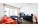 Inviting living room with fireplace, large window, and modern furnishings at 1323 Elati St # 3, Denver, CO 80204