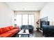 Bright living room featuring a fireplace, large window and dual sofas at 1323 Elati St # 3, Denver, CO 80204