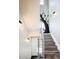 Modern staircase with open railing and a whimsical tree mural on the wall at 1323 Elati St # 3, Denver, CO 80204