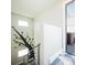 Staircase with tree mural opens to a rooftop patio and hot tub at 1323 Elati St # 3, Denver, CO 80204