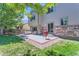 Cozy backyard patio with stone accents, a grill, and ample seating, perfect for entertaining at 2312 Dogwood Dr, Erie, CO 80516