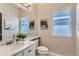 Clean bathroom featuring a white vanity, modern faucet, and a large mirror at 2312 Dogwood Dr, Erie, CO 80516