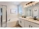 Bathroom featuring a large soaking tub, glass-enclosed shower, and double vanity with modern fixtures at 2312 Dogwood Dr, Erie, CO 80516