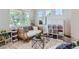 Bright room featuring a comfy daybed, decorative shelving, and stylish decor at 2312 Dogwood Dr, Erie, CO 80516