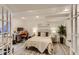 Comfortable bedroom with hardwood floors, workstation, decorative headboard and plenty of natural light at 2312 Dogwood Dr, Erie, CO 80516