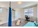 Bright bonus room featuring a hanging swing, desk area, and comfortable lounge seating at 2312 Dogwood Dr, Erie, CO 80516