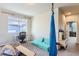 Bonus room with gray carpet features aerial swing, light-filled windows and space for play or study at 2312 Dogwood Dr, Erie, CO 80516