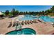 Large community pool with water slides, lounge chairs, and a hot tub for relaxation at 2312 Dogwood Dr, Erie, CO 80516