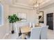 Stylish dining room showcases modern lighting and a view into other rooms at 2312 Dogwood Dr, Erie, CO 80516