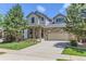 Charming two-story home with a stone facade, lush lawn, and a spacious two-car garage at 2312 Dogwood Dr, Erie, CO 80516