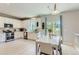 Spacious kitchen with stainless steel appliances open to the dining area and backyard views at 2312 Dogwood Dr, Erie, CO 80516