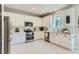 Bright kitchen featuring white cabinets, stainless steel appliances, and a subway tile backsplash at 2312 Dogwood Dr, Erie, CO 80516