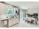 Bright, open kitchen with stainless appliances and an adjacent dining area with a table and chairs at 2312 Dogwood Dr, Erie, CO 80516